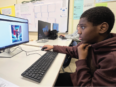 student at computer designing superhero